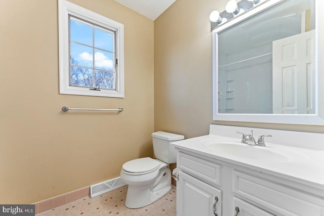 bathroom featuring toilet, vanity, visible vents, tile patterned floors, and walk in shower