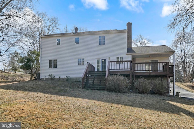 rear view of property featuring stairway, a lawn, a chimney, and a wooden deck