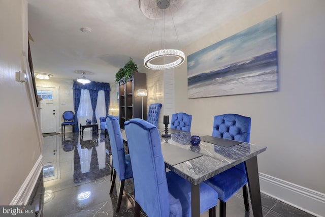 dining area with marble finish floor and baseboards