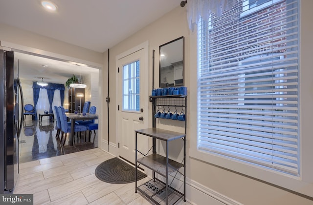 doorway to outside with baseboards