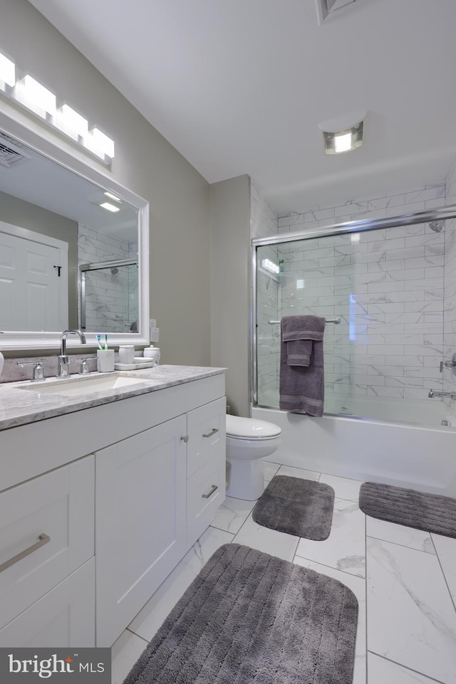 full bath with marble finish floor, bath / shower combo with glass door, visible vents, toilet, and vanity