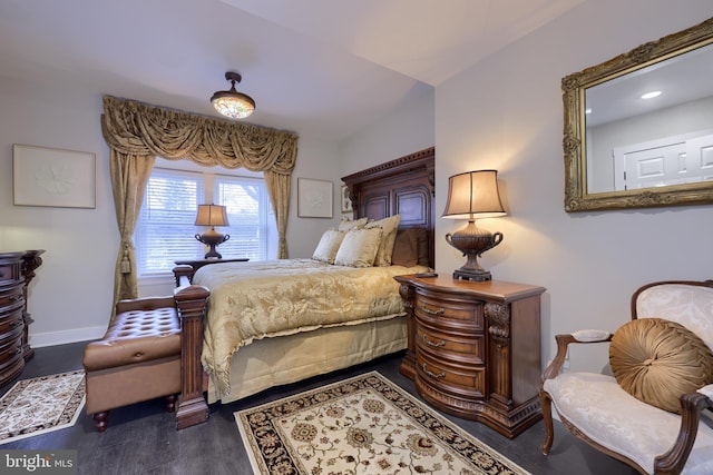 bedroom with dark wood-style flooring and baseboards