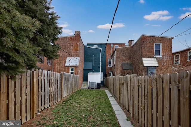 exterior space featuring cooling unit and a fenced backyard