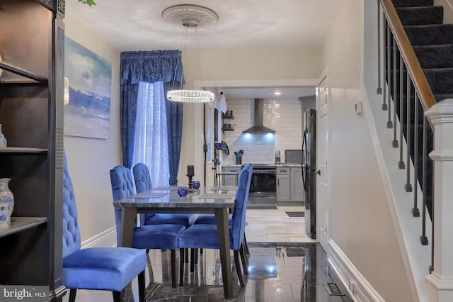 dining area featuring stairs and baseboards