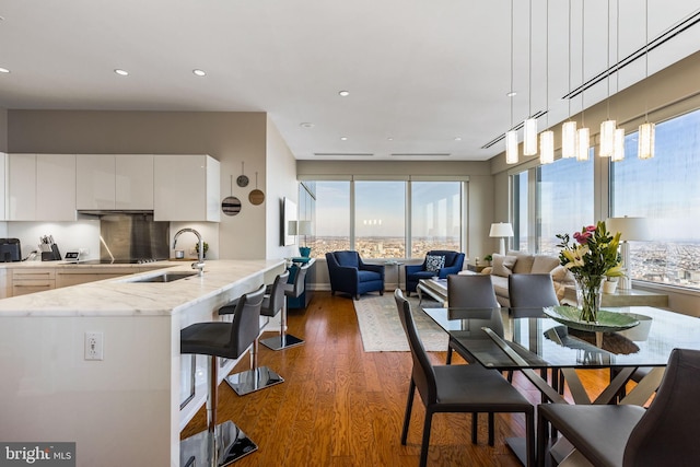 dining room with recessed lighting, dark wood finished floors, and baseboards