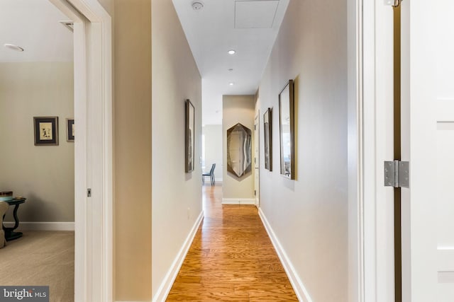 corridor with recessed lighting, light wood finished floors, and baseboards