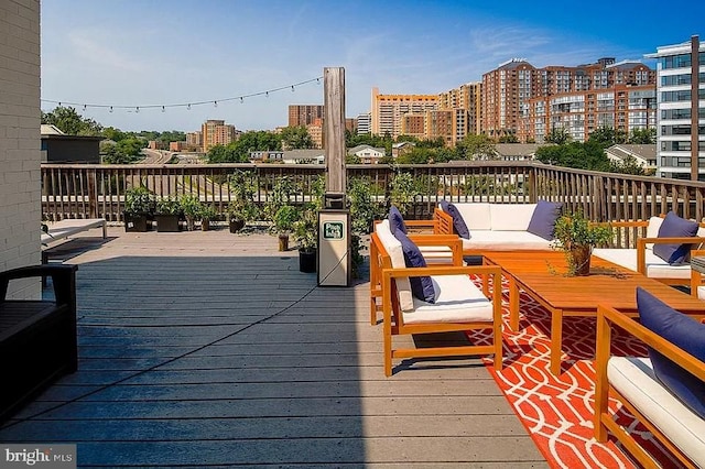 wooden deck featuring a city view and outdoor lounge area