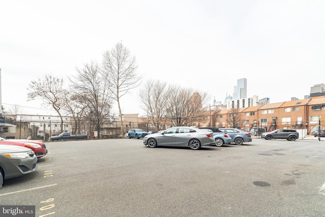 view of vehicle parking with a city view