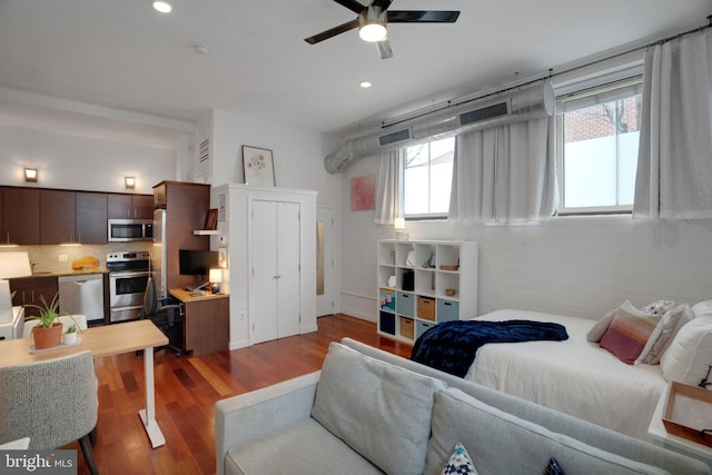 bedroom with wood finished floors, a ceiling fan, and recessed lighting