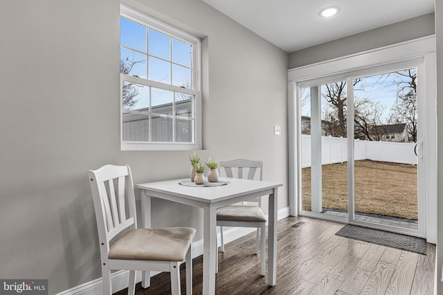 dining room with baseboards and wood finished floors