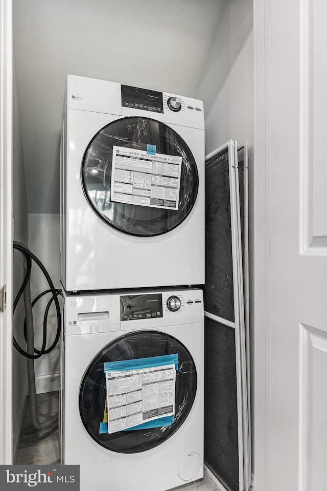 laundry room with laundry area and stacked washing maching and dryer