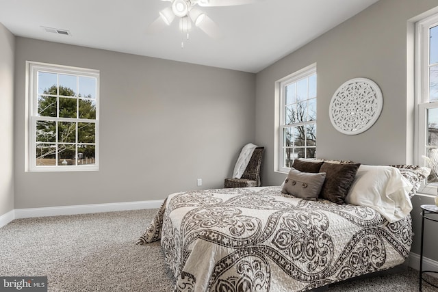 bedroom featuring carpet, visible vents, baseboards, and ceiling fan