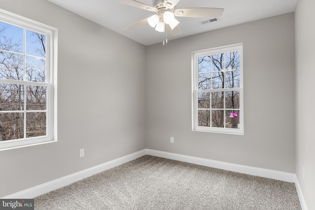 empty room with a ceiling fan, baseboards, visible vents, and carpet flooring