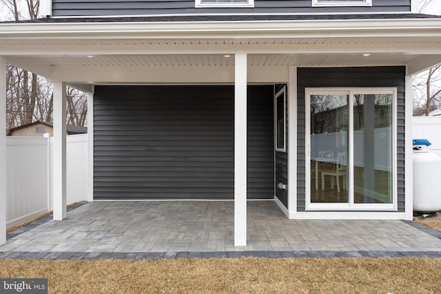 entrance to property featuring fence