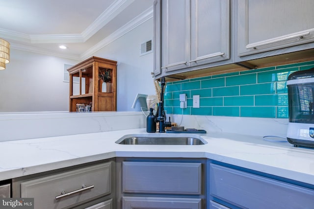 kitchen with visible vents, crown molding, backsplash, and gray cabinetry