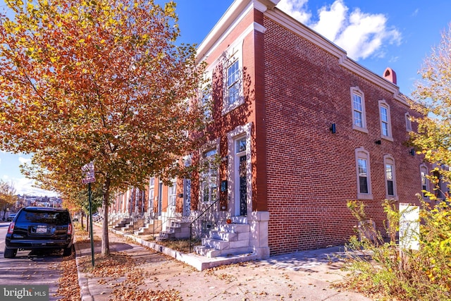 view of property exterior featuring brick siding