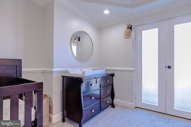 bedroom with french doors, light colored carpet, and crown molding