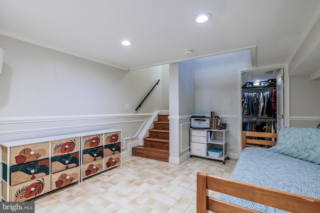 bedroom with wainscoting, ornamental molding, a decorative wall, and recessed lighting