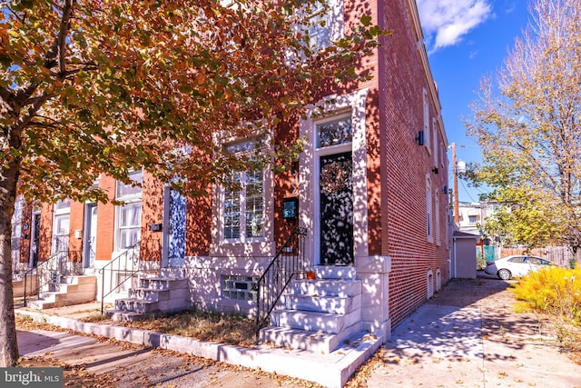 view of front of house featuring entry steps and brick siding