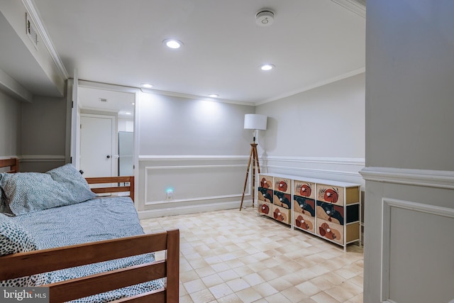 bedroom with a decorative wall, a wainscoted wall, recessed lighting, visible vents, and ornamental molding