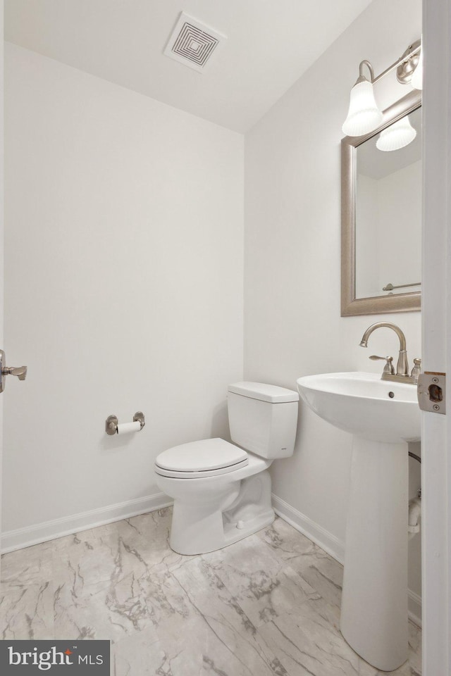 bathroom with visible vents, marble finish floor, toilet, and baseboards