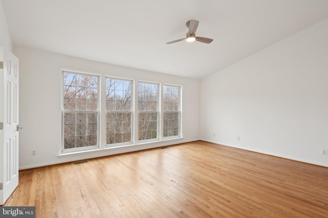 empty room with visible vents, ceiling fan, plenty of natural light, and light wood-style floors