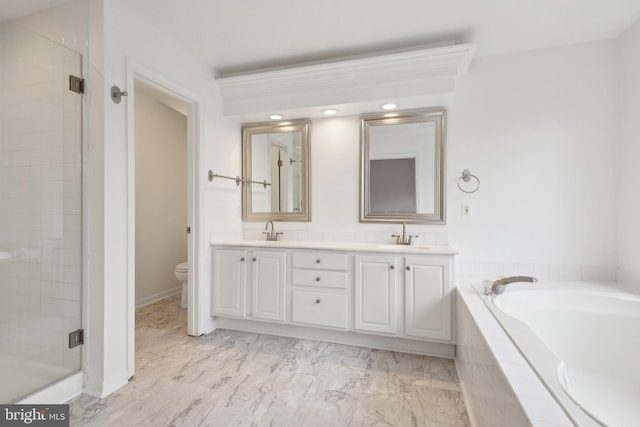 bathroom featuring a shower stall, toilet, double vanity, a bath, and marble finish floor