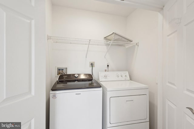 laundry room featuring washing machine and clothes dryer and laundry area