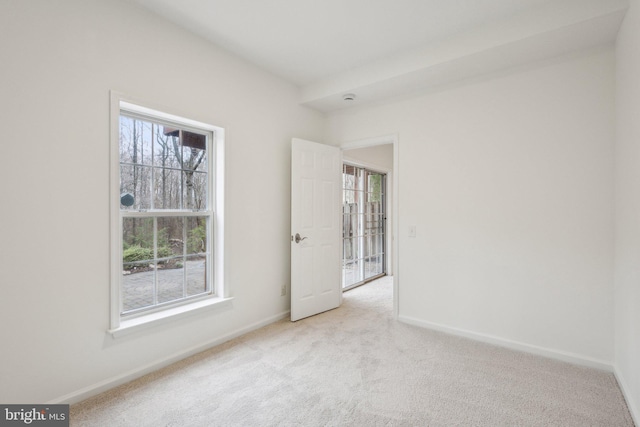 empty room featuring baseboards and carpet