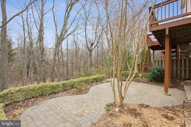 view of yard featuring a deck, stairway, and a patio area