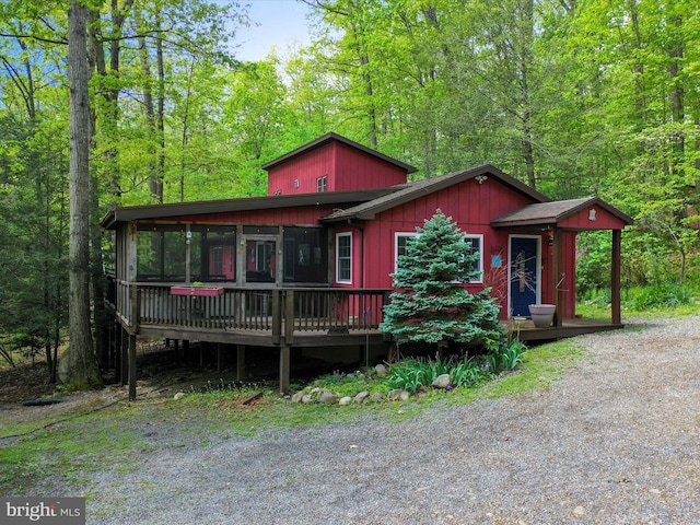 47 Timberline Dr, Lost River, WV 26810 - view of front facade featuring a sunroom, a wooden deck, and a view of trees