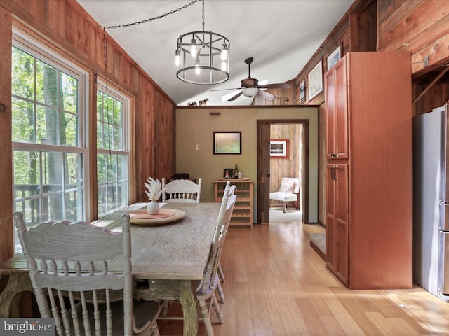 47 Timberline Dr, Lost River, WV 26810 - dining room featuring wooden walls, lofted ceiling, ceiling fan, light wood-style floors, and a chandelier