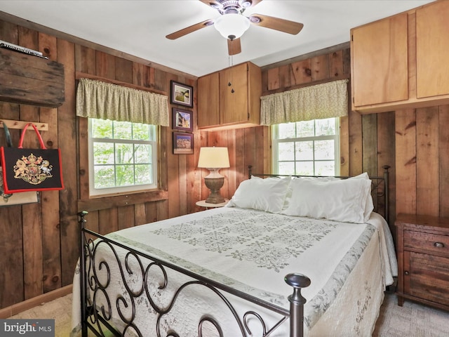 47 Timberline Dr, Lost River, WV 26810 - bedroom featuring wooden walls, multiple windows, light colored carpet, and ceiling fan