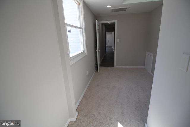 hall with recessed lighting, baseboards, visible vents, and light colored carpet