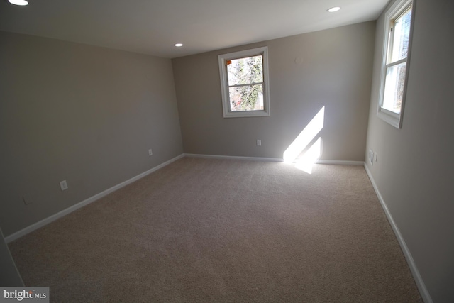 carpeted empty room featuring recessed lighting, plenty of natural light, and baseboards