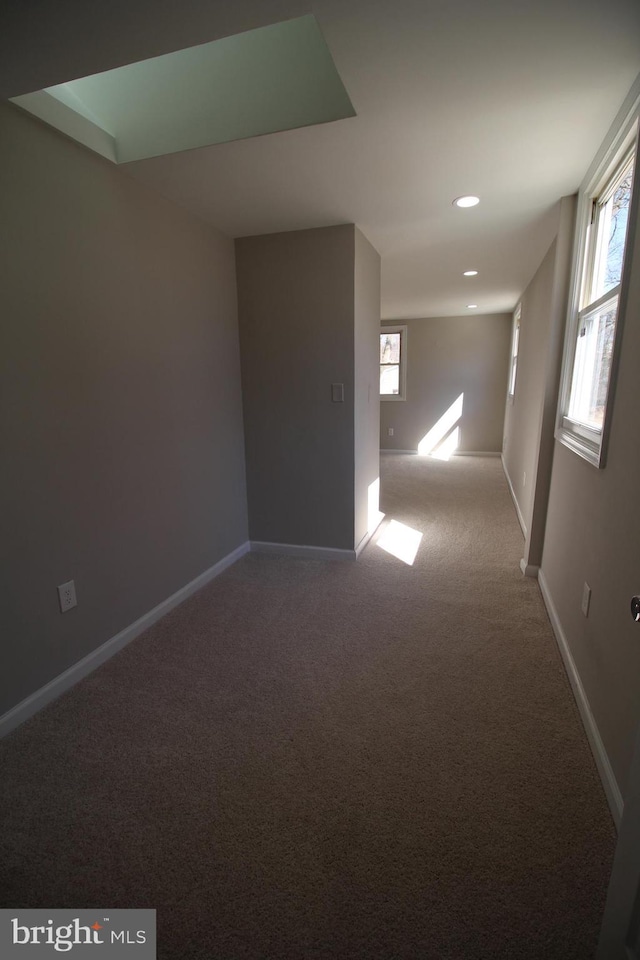 unfurnished room with baseboards, recessed lighting, carpet, and a healthy amount of sunlight