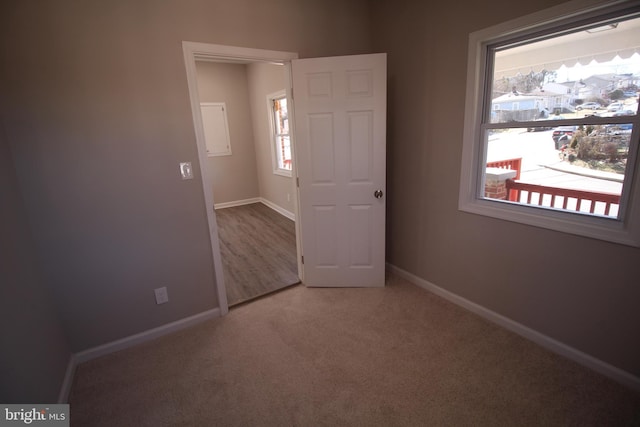 carpeted spare room with baseboards