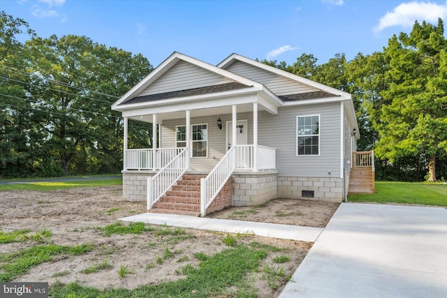 bungalow with a porch, crawl space, and a shingled roof