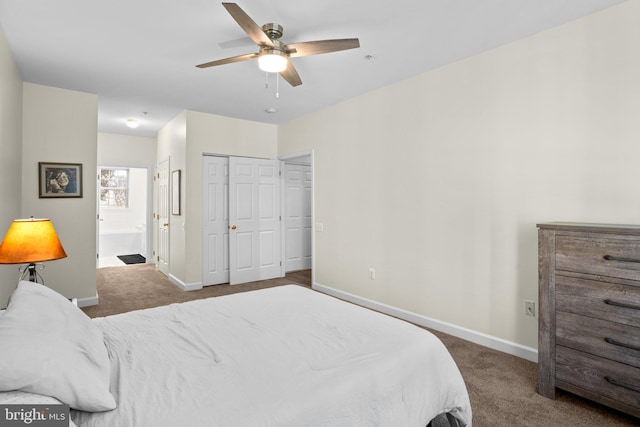 bedroom with a closet, ensuite bath, carpet flooring, and baseboards