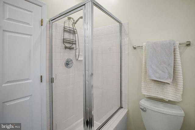 full bath featuring toilet and a stall shower