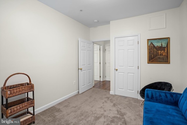 sitting room featuring carpet floors and baseboards