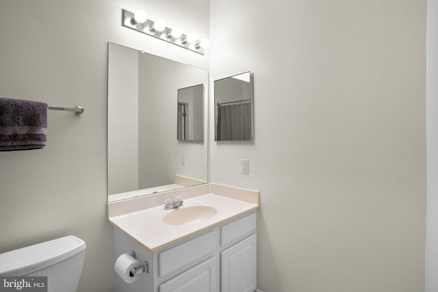 bathroom featuring vanity and toilet