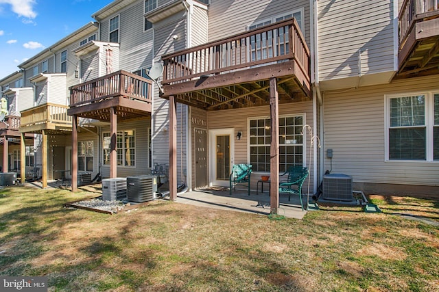 back of property featuring a patio area, central AC, and a lawn