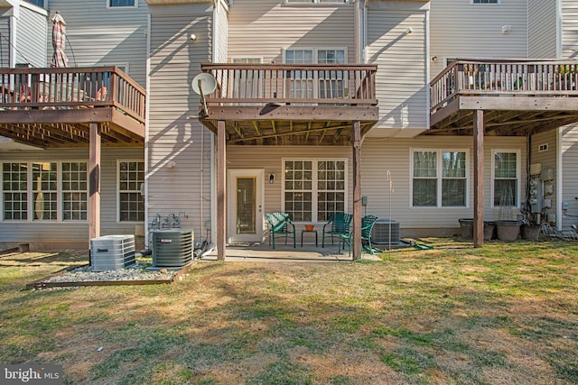 back of property with a patio area, central AC, a yard, and a wooden deck