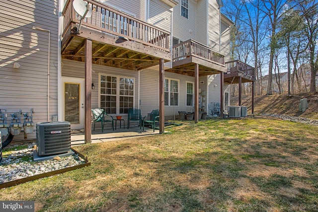 rear view of property featuring central AC, a lawn, and a patio area