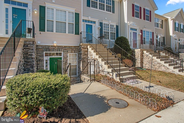 view of front of home with a residential view and stone siding