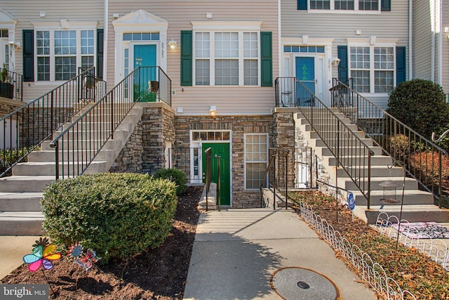 property entrance featuring stone siding