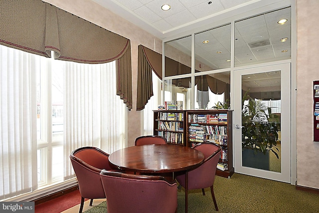 dining room with recessed lighting, a drop ceiling, and a healthy amount of sunlight