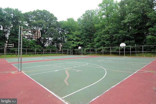 view of basketball court featuring community basketball court and fence