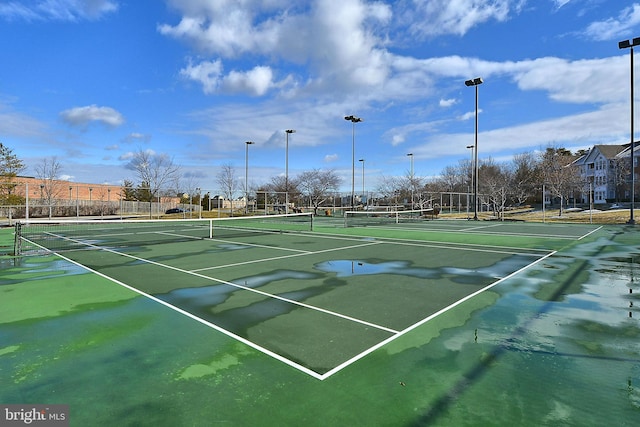 view of tennis court with fence